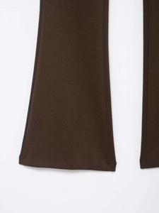 Close-up of the flared hem and stitching on dark brown high-waisted casual trousers