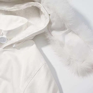 Detail of white hooded jacket with faux fur trim, soft fleece lining and button closure