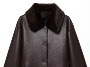 Detailed view of women's dark brown faux leather coat with plush black fur collar