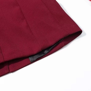 Détail de l'ourlet bordeaux montrant la texture sergé et la couture de finition