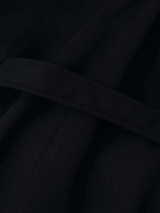 Detail of black wool coat belt showing reinforced stitching and heavy textured fabric