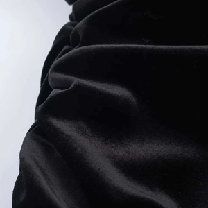 Primo piano di elegante velluto nero con trama lussuosa e dettagli arricciati