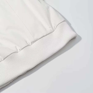 Macro shot of high-quality white ribbed cuff detail on this stylish winter hooded jacket