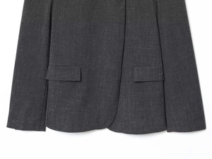 Detailed close-up of symmetrical flap pockets on grey blend fabric blazer jacket