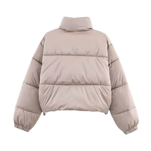 Rear view of beige oversized puffer jacket with adjustable drawstring and quilted panels