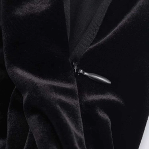 Elegant black velvet mini dress featuring a concealed zipper and structured shoulder pads