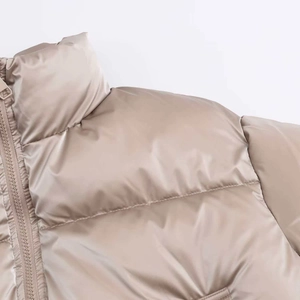 Detail of high collar and shiny champagne fabric on quilted windproof padded jacket