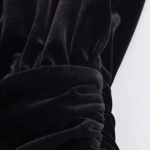 Detail of ruched sleeves on black velvet short dress with elegant texture and stitching
