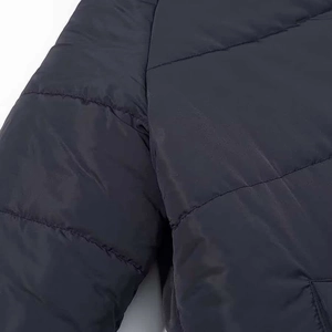 Detail view of reinforced shoulder seams and horizontal quilting on padded winter jacket