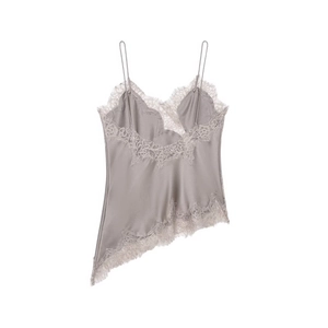 Detailed view of silver satin camisole with beige lace trim and asymmetric hem design