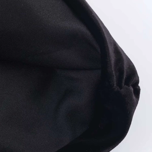 Detail shot of black velvet fabric texture with knit hem and padded shoulder structure