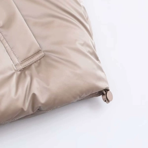 Detail of water-resistant glossy fabric with quilted seams and adjustable drawstring hem