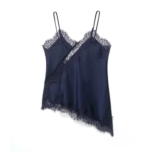 Detail of navy blue satin camisole showing delicate lace trim and asymmetrical hemline