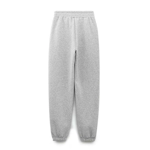 Detail of light grey joggers featuring elastic waistband and ribbed cuffs in soft cotton