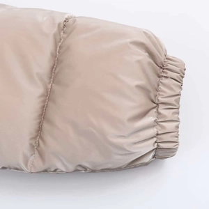 Close-up of windproof elastic cuffs and shiny water-resistant fabric on the puffer jacket