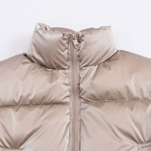 Detail of windproof shiny khaki puffer vest with stand collar and zipper closure