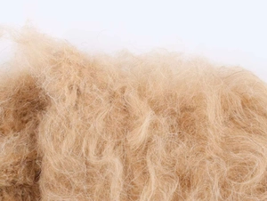 Macro shot of fluffy beige long-pile faux fur texture showing soft plush fibers
