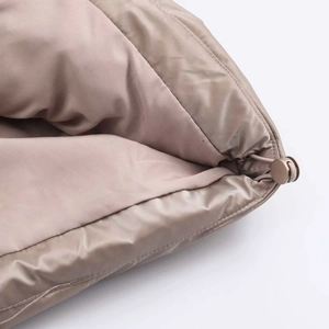 Detailed close-up of drawstring and elastic toggle on glossy windproof puffer jacket