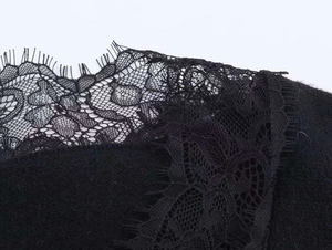 Detail shot of intricate black eyelash lace stitching on elegant knitwear fabric