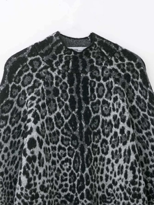Close-up of leopard jacquard knit sweater with fuzzy texture and high neckline