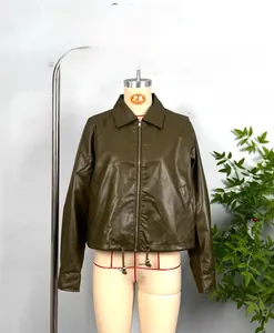 Detail shot of olive green faux leather jacket featuring drawstring hem and zipper closure