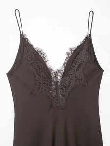 Detailed view of dark brown satin dress featuring delicate eyelash lace along the V-neckline
