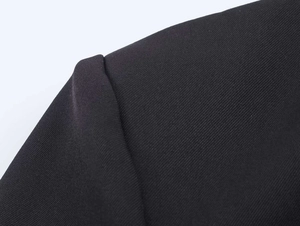 Close-up of black satin-tie blazer shoulder showing high-quality twill fabric texture