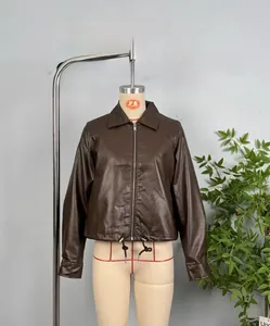 Detail view of the drawstring hem and smooth dark brown PU leather texture of the jacket