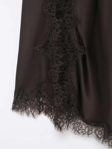 Detailed close-up of premium black silk satin fabric with elegant eyelash lace trim