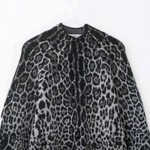 Relaxed leopard jacquard knit sweater featuring a stylish high neckline and soft grey tones
