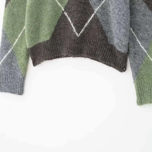 Classic argyle knit sweater in green and grey with soft ribbed cuffs and hem detail