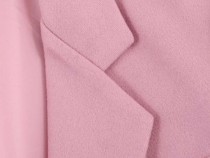 Macro shot of notch lapel and fine woolen texture on this elegant pink autumn coat