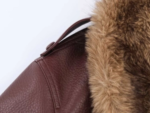 Macro view of dark brown faux leather texture and thick brown faux fur collar detail