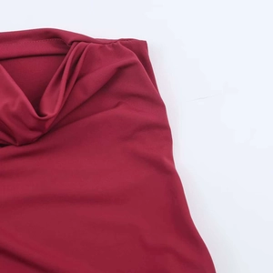 Close-up detail of wine red sleeveless maxi dress with elegant draped pleated neckline