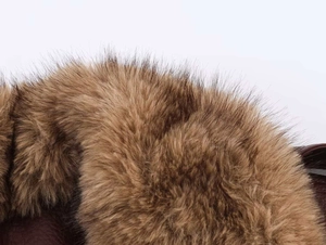 Close-up of fluffy brown faux fur collar and dark faux leather jacket detail