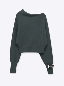 Detailed view of dark grey knit sweater featuring off-shoulder neck and silver metal ring cuffs