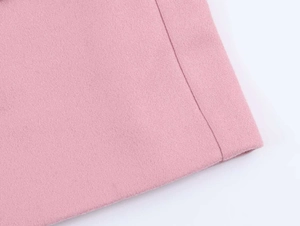 Close-up of pink wool blend fabric texture showing fine stitching and premium craft