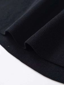 Macro shot of fine black ribbed knitting texture and high-quality edge stitching details