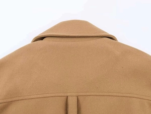 Detailed close-up of the back collar and stitching on camel wool blend coat