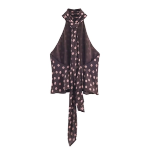 Detail of coffee brown halter neck top with pink polka dots and long tie ribbons