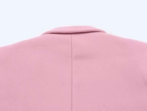 Detail of light pink wool jacket back seam and collar texture with premium stitching