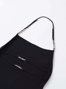 Detail of black halter knit top featuring metallic silver bead accents on slim straps