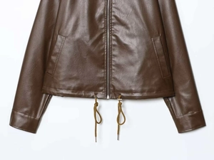 Detail of dark brown faux leather jacket featuring drawstring hem and zipper closure