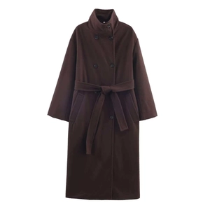 Close-up of dark brown double-breasted coat with stand collar and waist belt detail