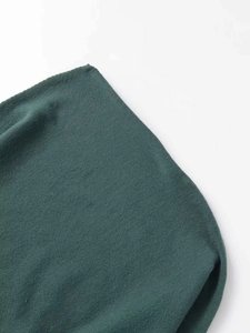 Detailed macro view of soft dark green knit texture and fine stitching workmanship