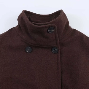 Close-up of high-neck wool coat with side buttons in deep chocolate brown finish
