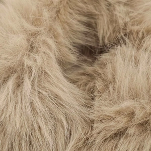 Macro shot showing soft camel faux fur texture with long fluffy synthetic fibers