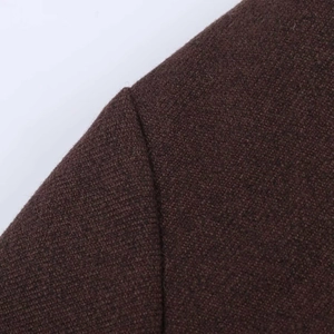 Detailed macro view of dark brown tweed fabric and high-quality shoulder stitching