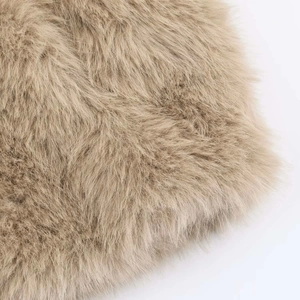 Macro shot of camel faux fur jacket texture showing soft and dense long hair detail