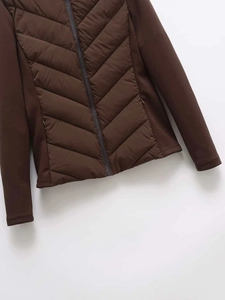 Detailed view of dark brown quilted winter jacket with hybrid stitch sleeves and front zipper
